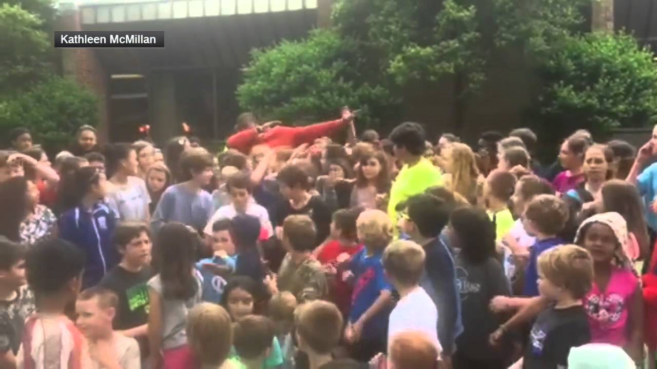 Cam Newton hits the dab with school yard full of kids