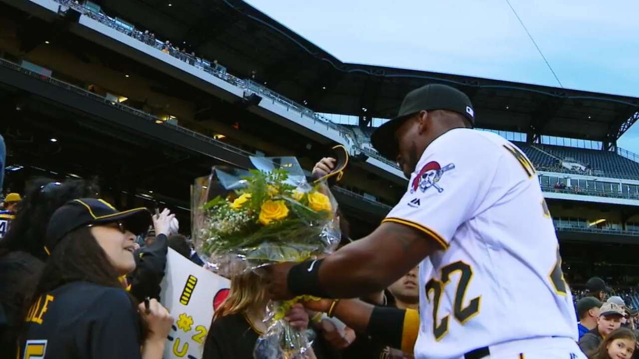 Fan gives Andrew McCutchen a bouquet of flowers before the game