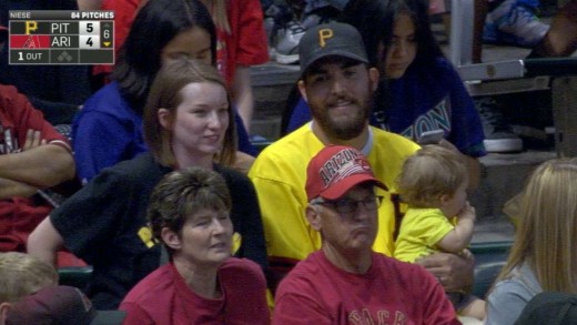 Father makes outstanding home run grab while holding baby