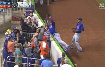 Cubs’ Javier Biaz dives into the stands to make the catch