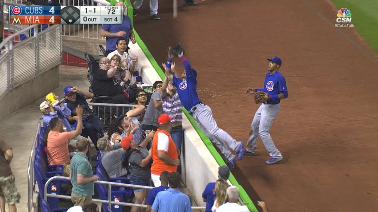 Cubs' Javier Biaz dives into the stands to make the catch