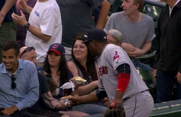 Juan Uribe pretends to go for a fan’s hot dog
