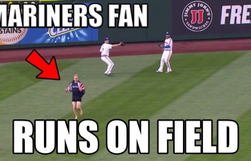 Seattle Mariners fan runs on the field during fly ball