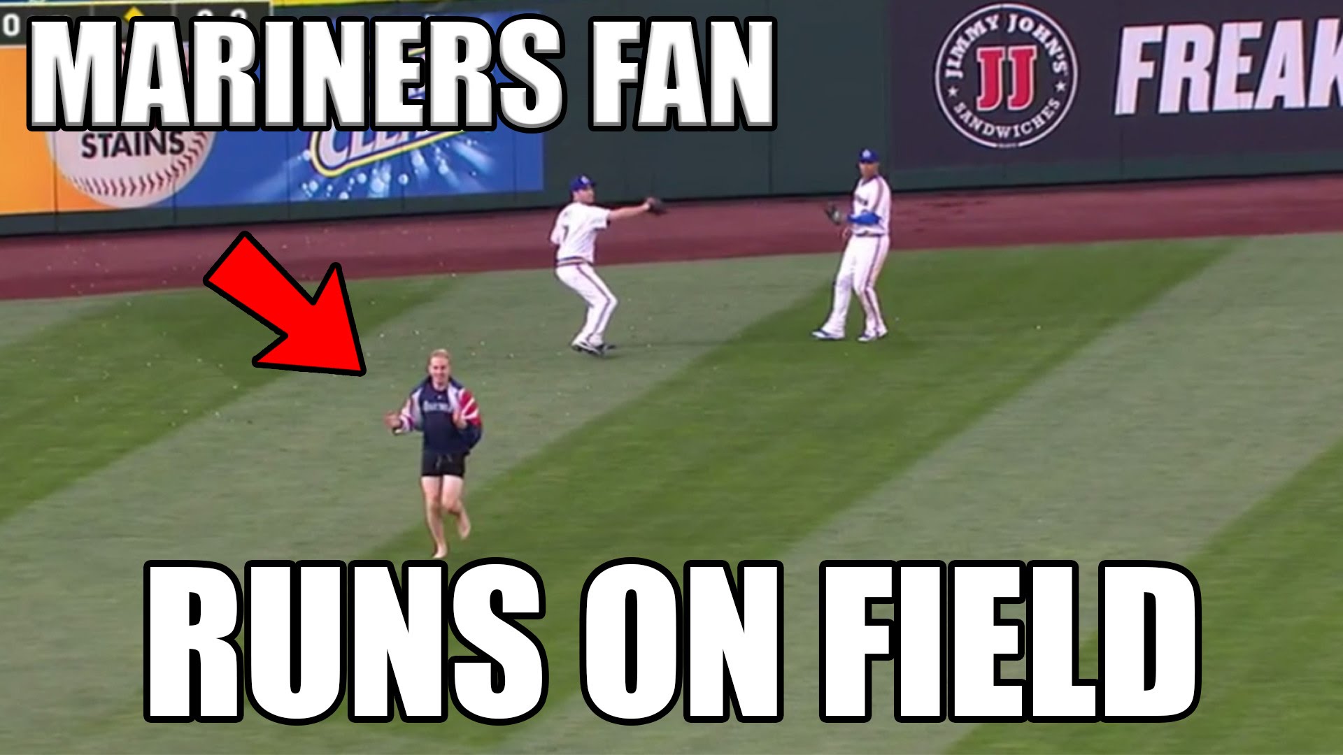 Seattle Mariners fan runs on the field during fly ball