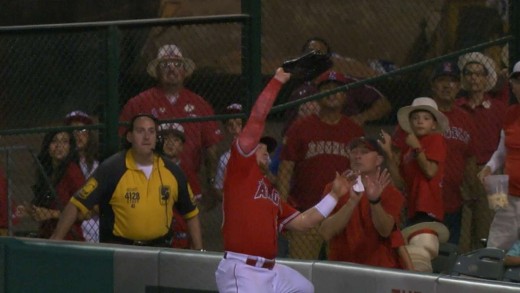 Kole Calhoun leaps to take a home run away from Kyle Seager