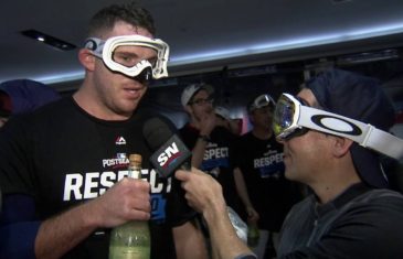 Blue Jays pitcher Joe Biagini pretends champagne bottle is a microphone