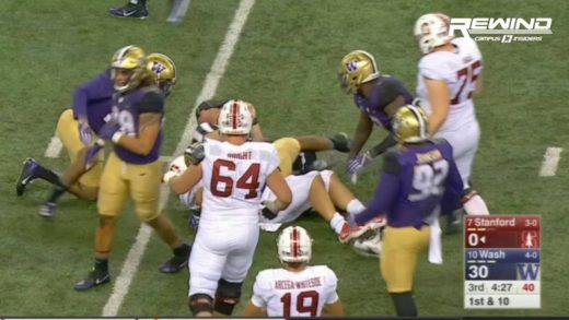 Christian McCaffrey gets tackled by a ref during Stanford vs. Washington