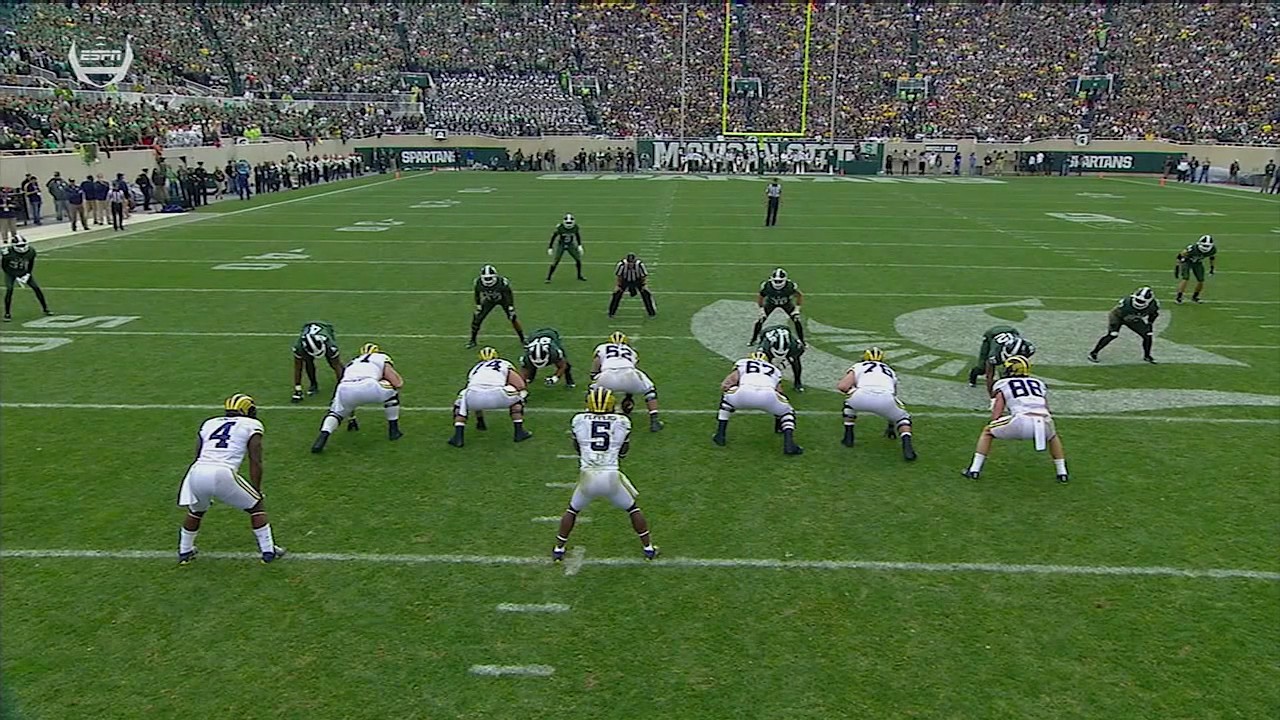 Jabrill Peppers spins between two Defenders vs. Michigan State
