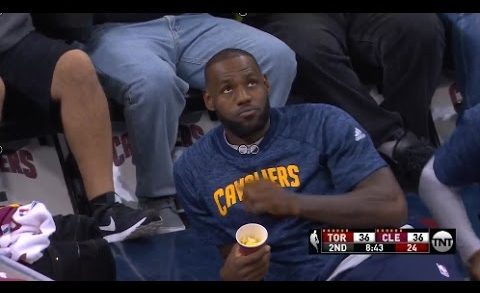 LeBron James eats popcorn court side during pre-season game