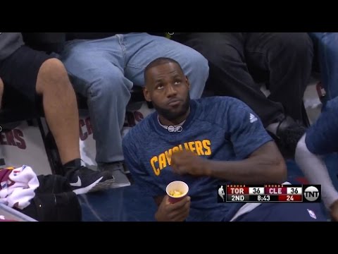LeBron James eats popcorn court side during pre-season game