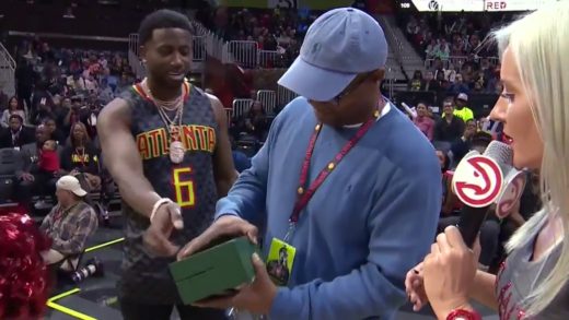 Atlanta rapper Gucci Mane gives away a Rolex watch to a fan at the Hawks game