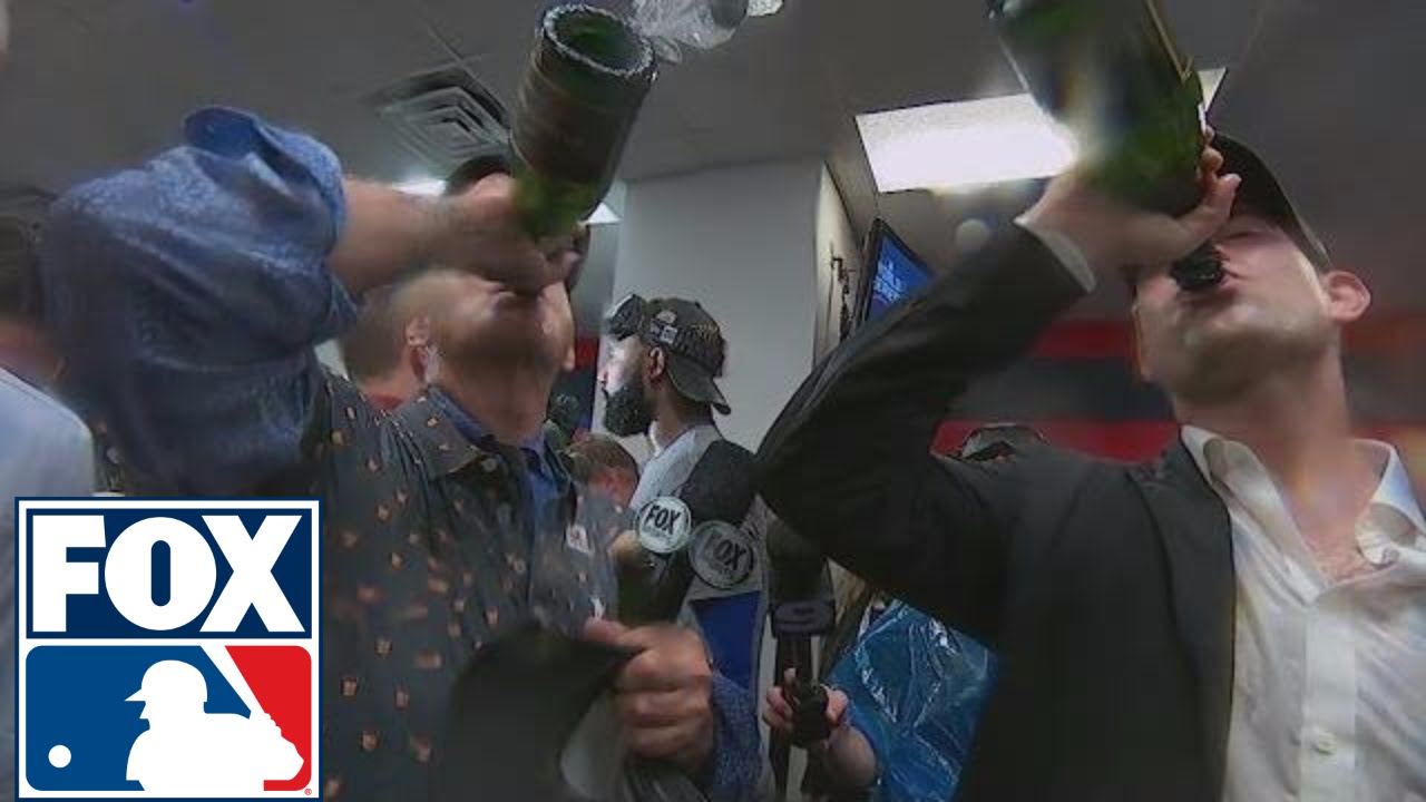 Bill Murray chugs champagne with Cubs president Theo Epstein