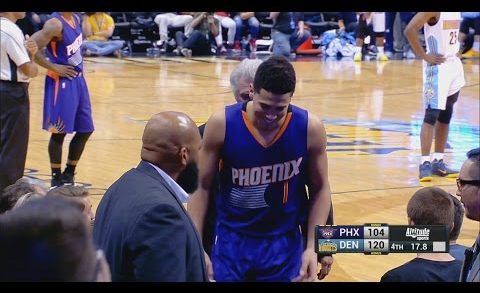 Devin Booker signs autograph for a fan after being ejected