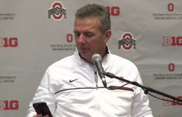 Urban Meyer takes a phone call from his wife during Ohio State’s press conference