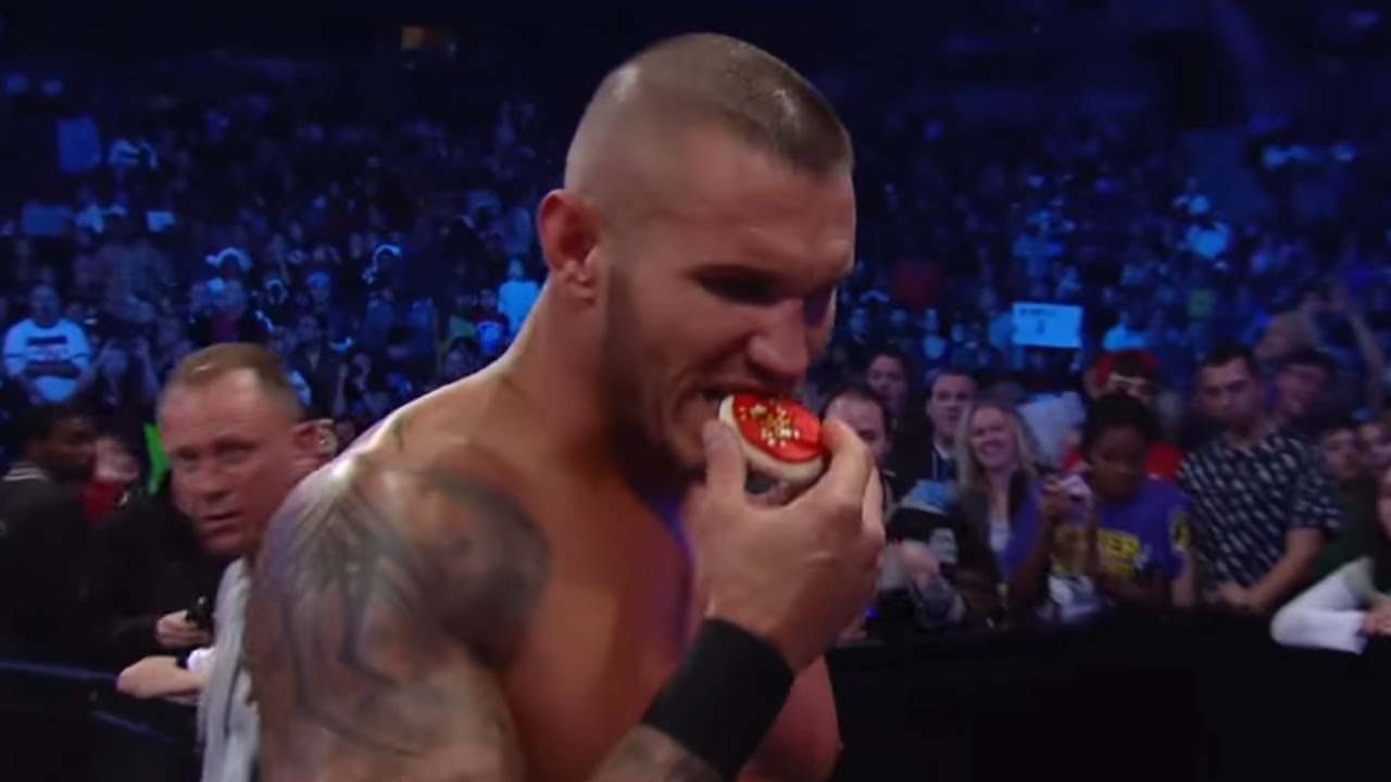 Randy Orton takes a moment to eat Christmas cookies during a match