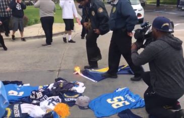 San Diego Chargers fan attempts to burn team flag at Chargers headquarters