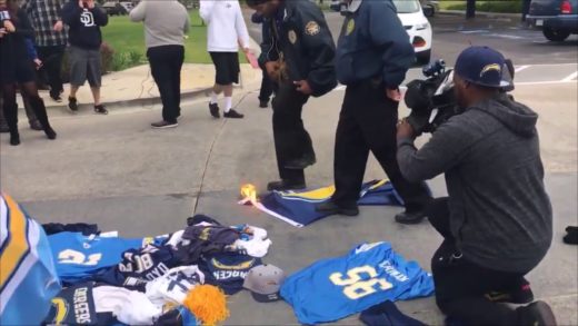 San Diego Chargers fan attempts to burn team flag at Chargers headquarters