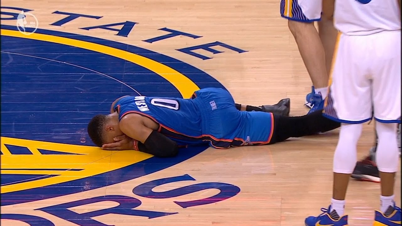 Zaza Pachulia stands over Russell Westbrook after knocking him over