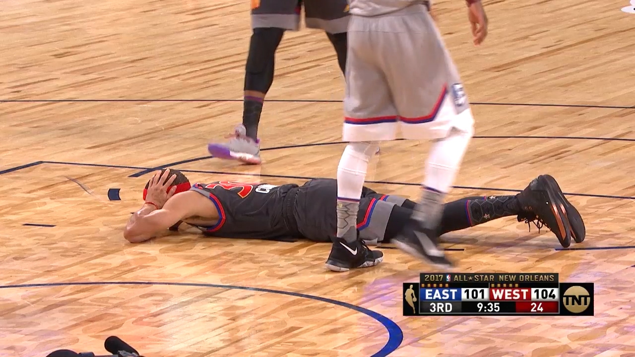 Steph Curry lays down on the court to avoid Giannis Antetokounmpo dunk