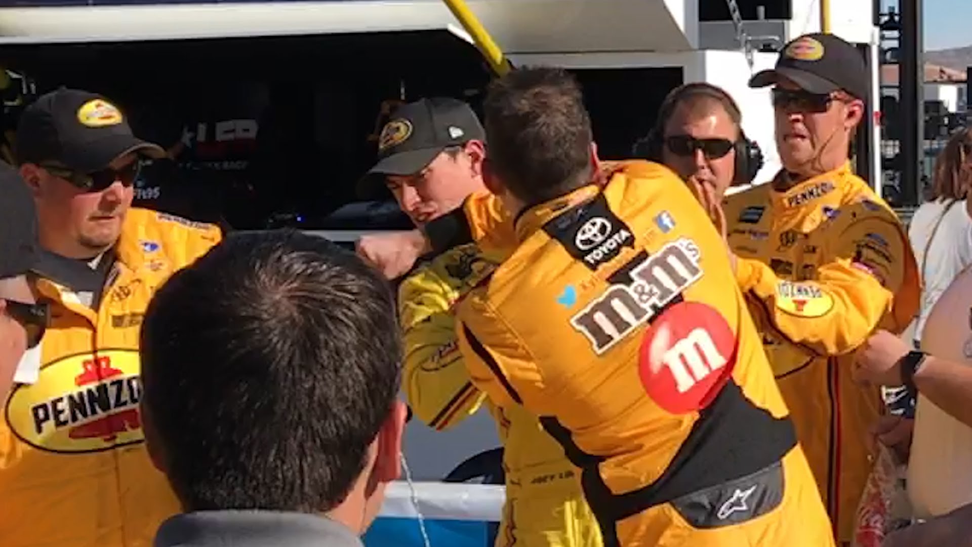 NASCAR racer Kyle Busch punches Joey Logano in the face