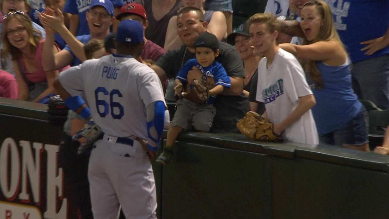 Yasiel Puig attempts to give a young fan a ball 2 times, 3rd time is the charm