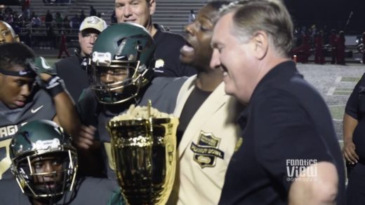 LaDainian Tomlinson presents DeSoto High School with Peanut Bowl Trophy